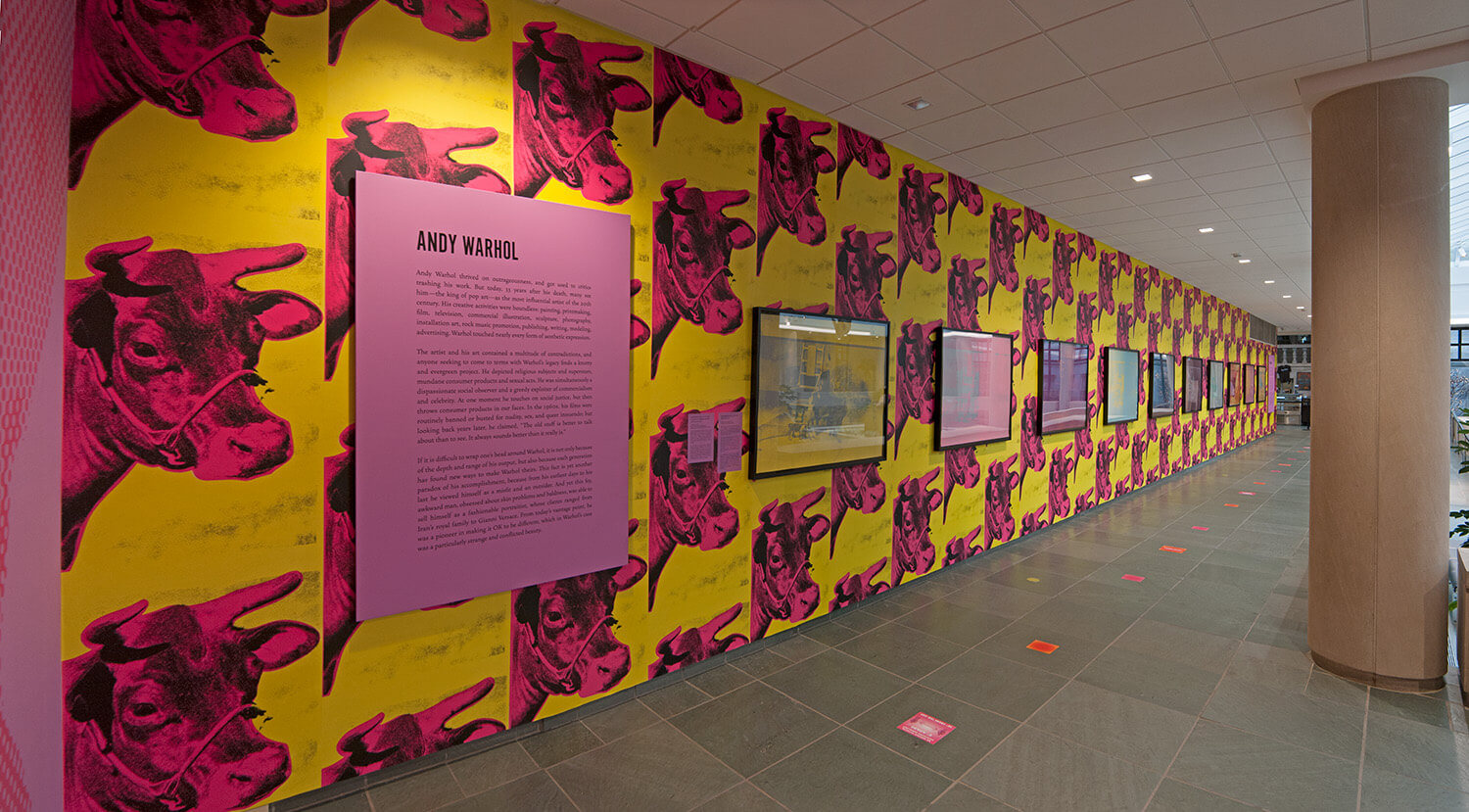 One wall of the Vanden Brul Pavilion is covered in a repeating yellow and pink wallpaper of a cow's head.
