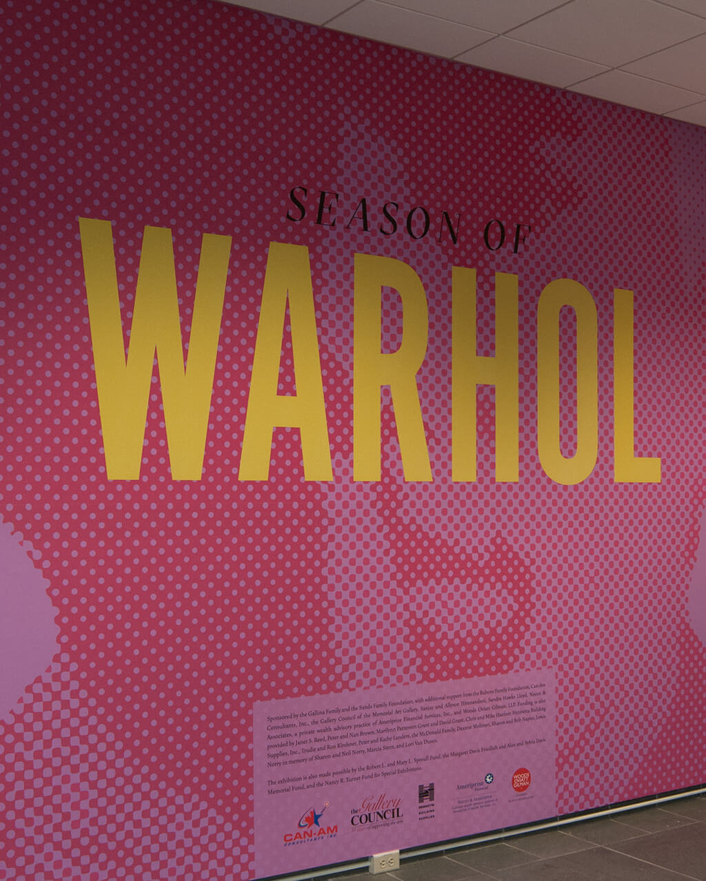 The title wall of "Season of Warhol" on a wall in MAG's Vanden Brul Pavilion.