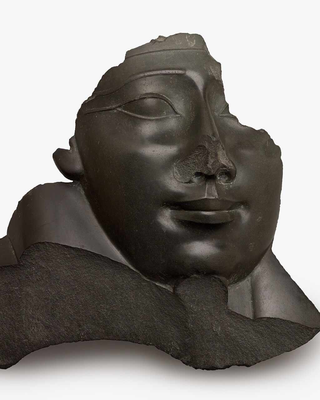 A broken sculpture of a face from a sarcophagus.