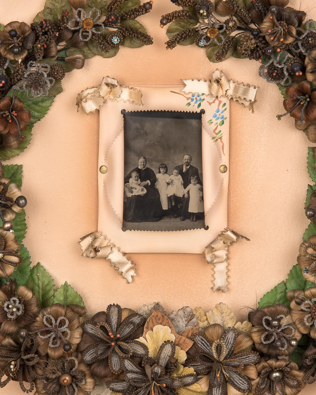 A floral hair wreath surrounding a photo of a family.