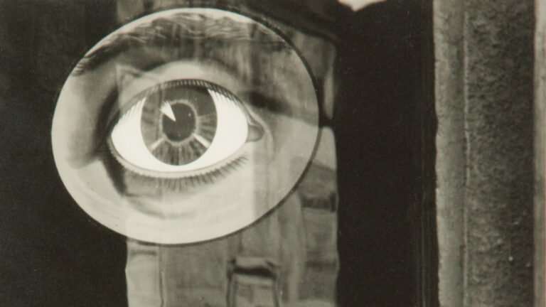 Collage of a drawing of an eye over an unclear background.