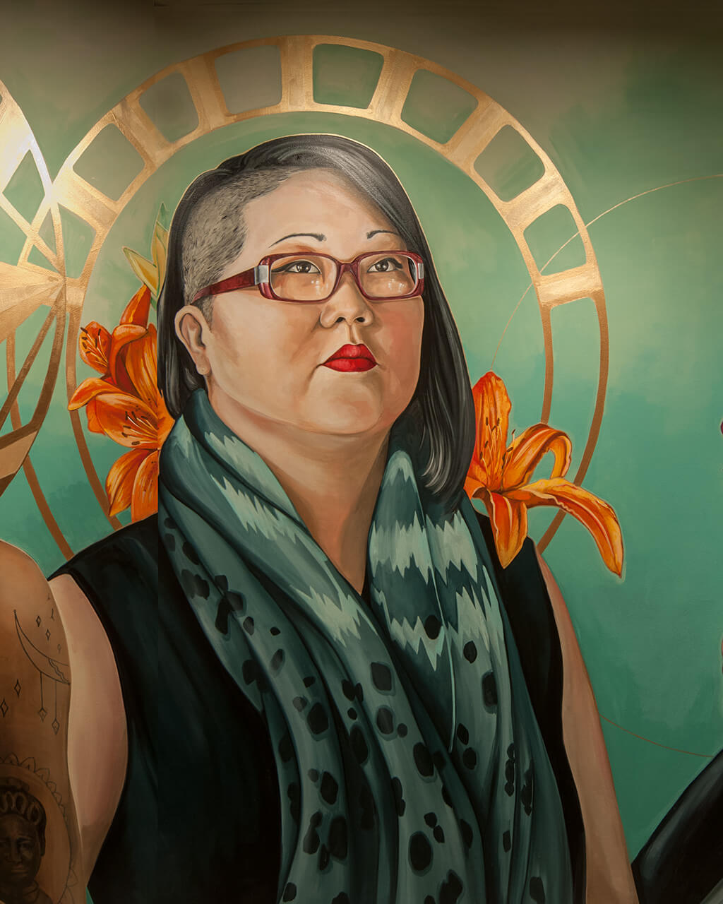 Part of the "Prelude" mural, showing women painted against a deep green background, gold halos around their heads.