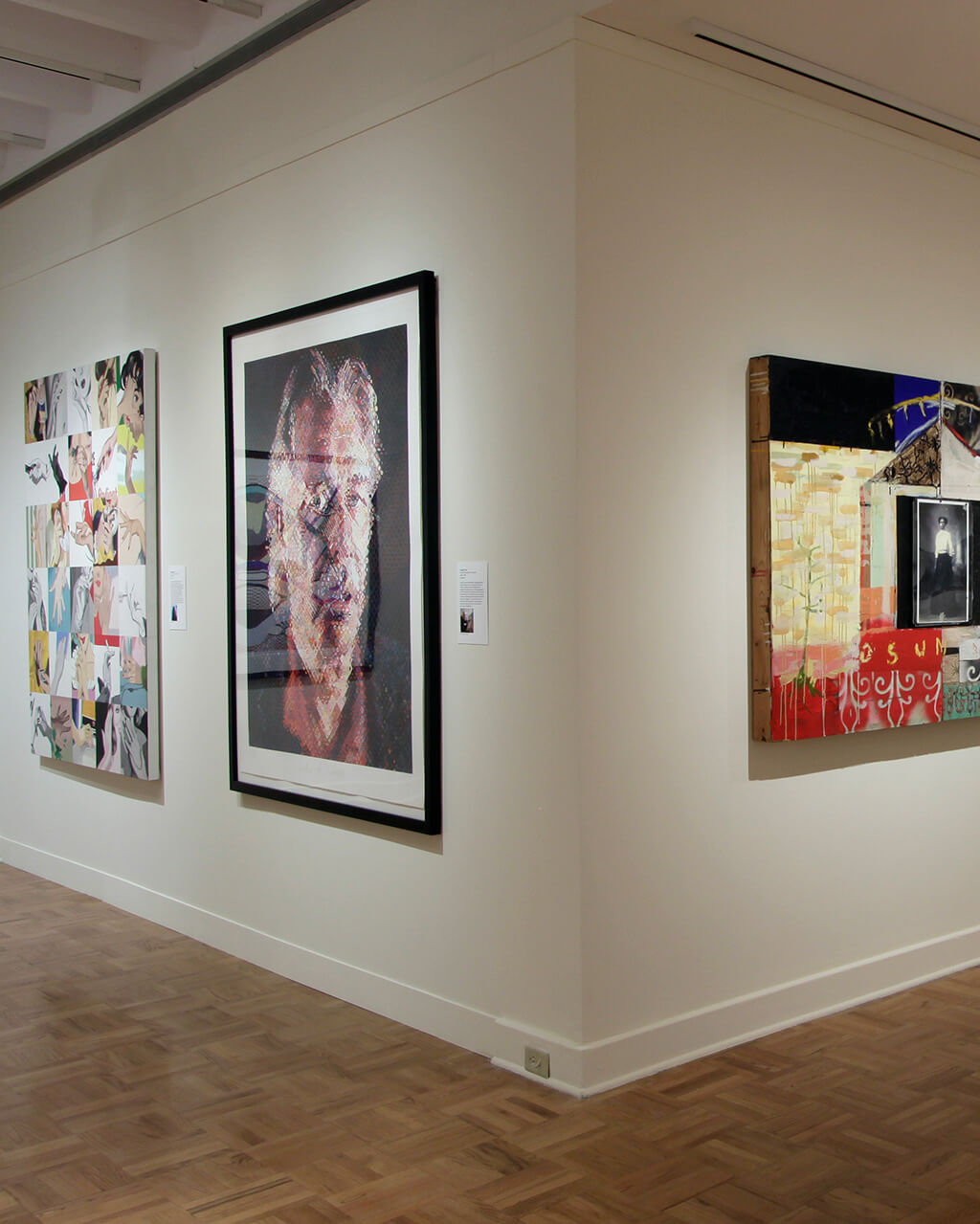 Framed works of art by many artists that all depict human beings in different ways hung on white walls in a gallery.