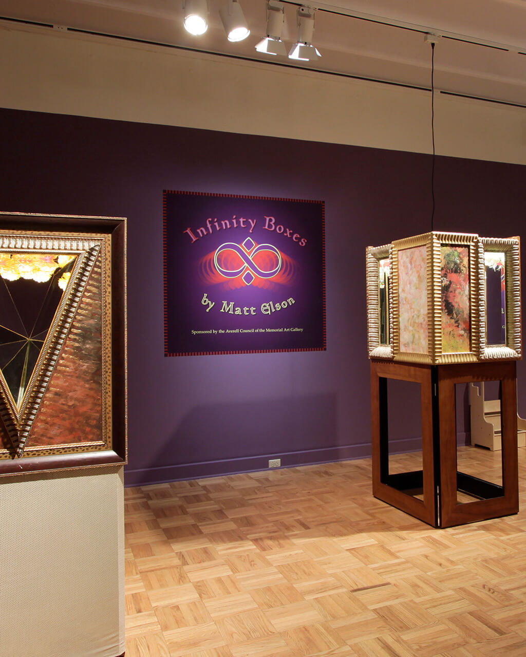 Several of Matt Elson's Infinity Boxes in a gallery space with purple walls.