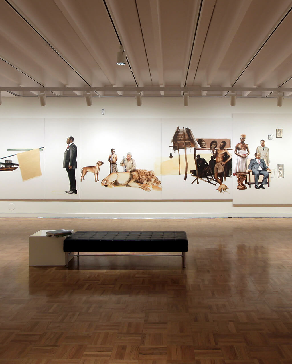 Frameless paintings of people and animals ring the white walls of MAG's Grand Gallery.