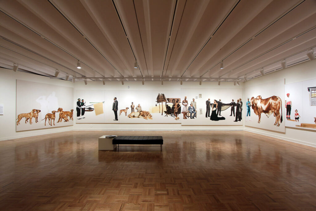 Frameless paintings of people and animals ring the white walls of MAG's Grand Gallery.