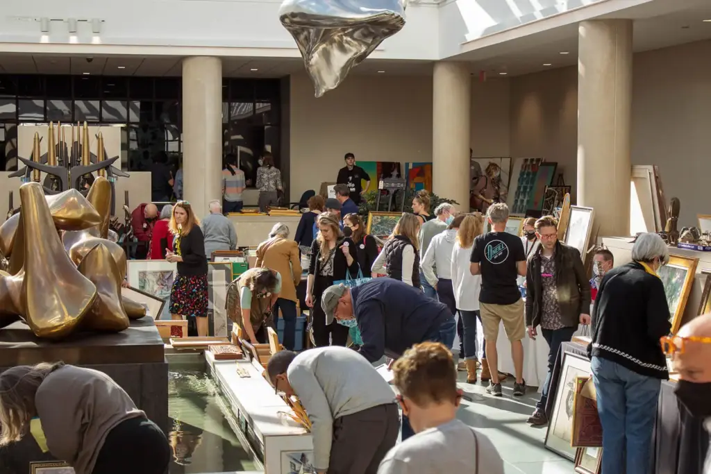 Shoppers looking through paintings in the Vanden Brul Pavilion at the 2022 Art & Treasures Sale.