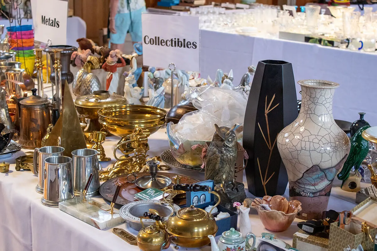 A table of collectible goods, from vases to own statues, on sale during the 2022 Art & Treasures Sale.