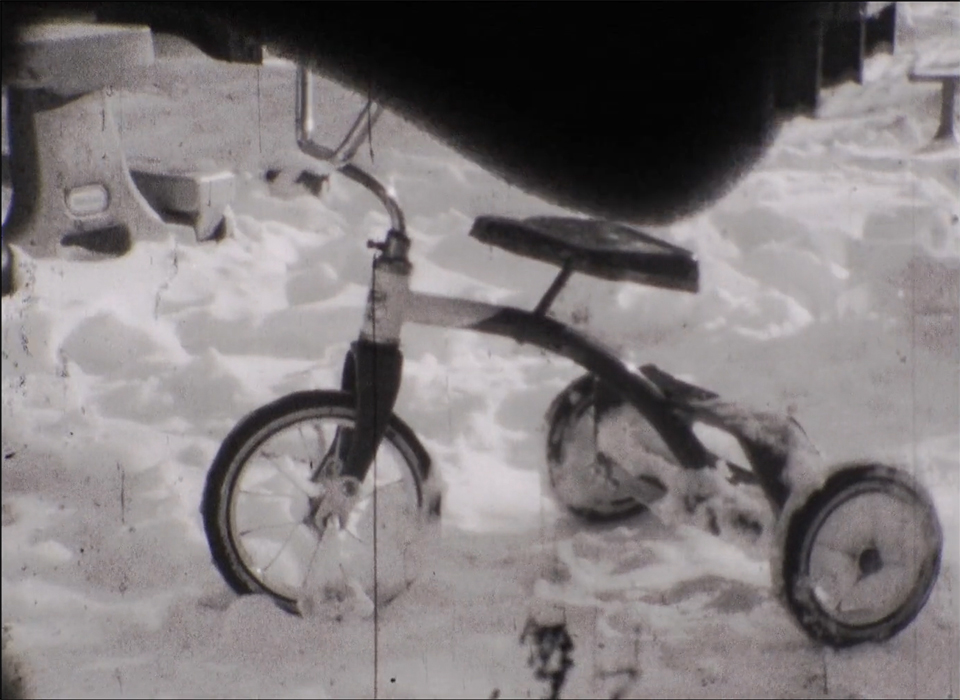 Black and white image oh a trike in the snow