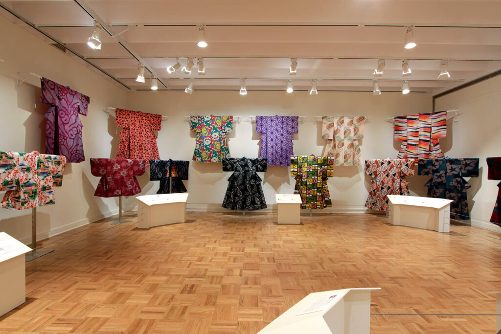 Kimono hung for display in a white-walled gallery space.