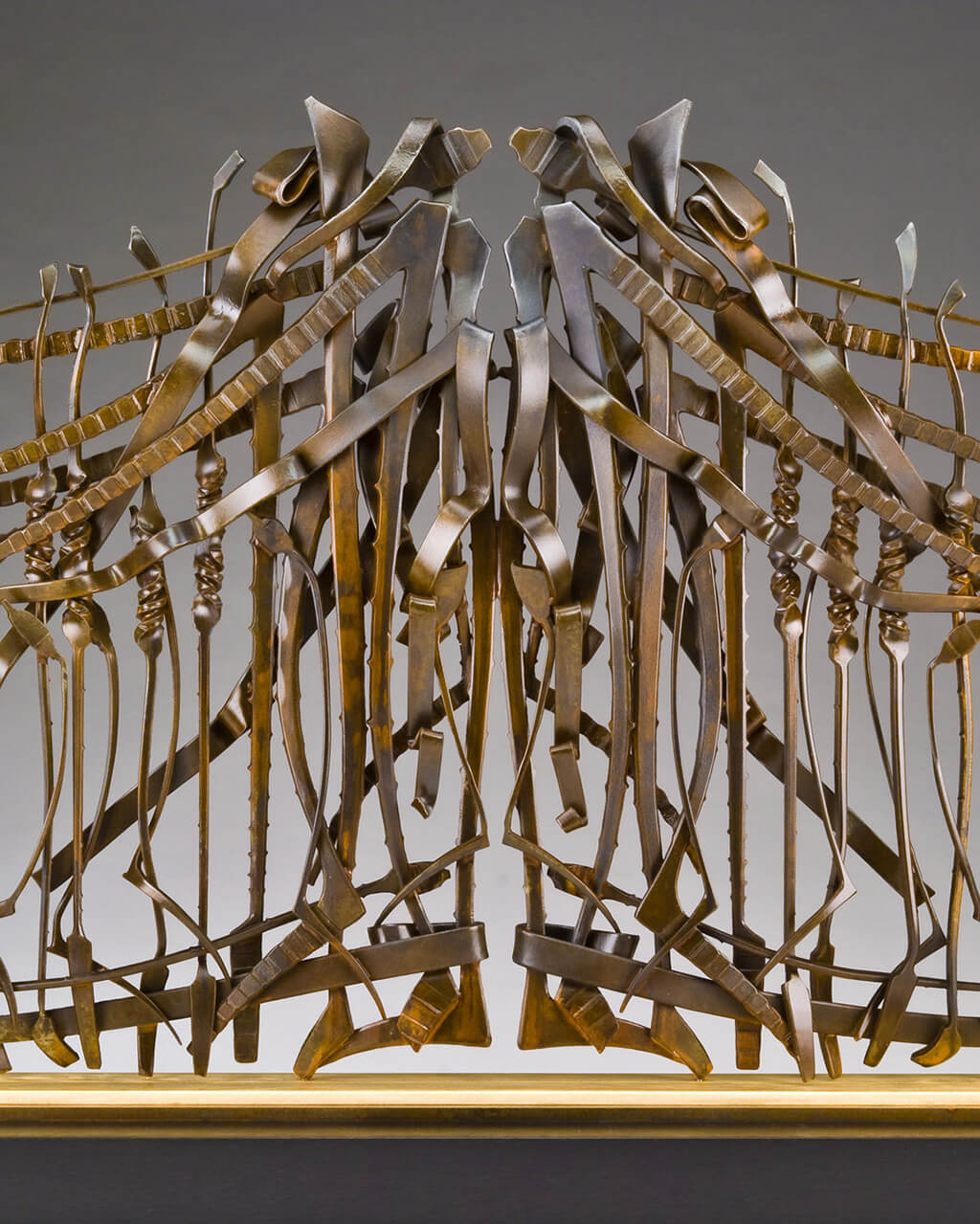 Intricate and ornate bronze-colored gate.