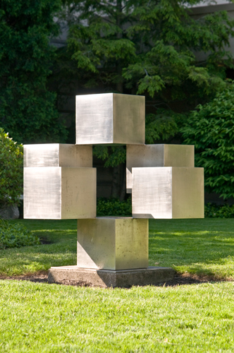 Steel sculpture of six cubes, connected at their corners and appearing to hover in space