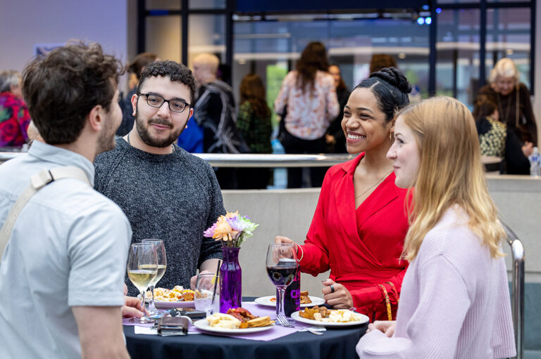 Young people talking at a patron members' party