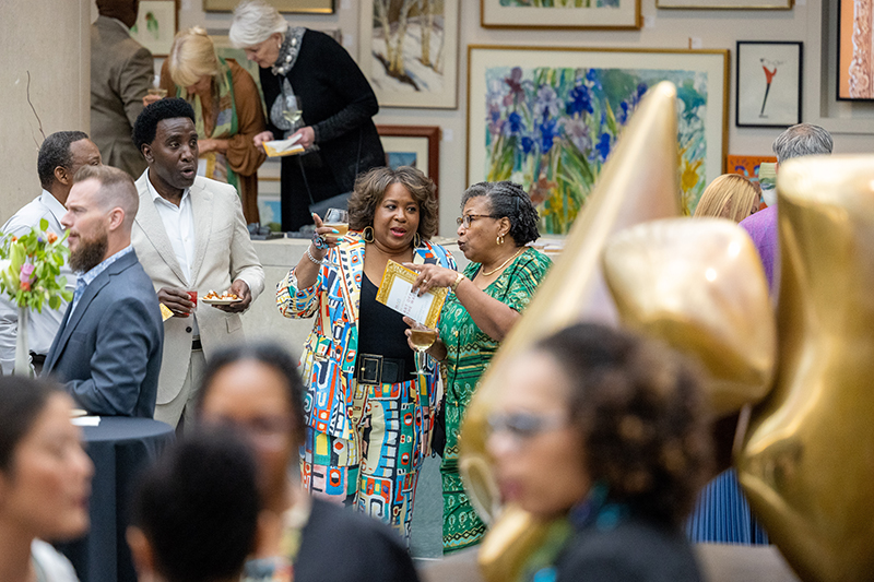 Members talk with each other while surrounded by art at MAG's annual gala