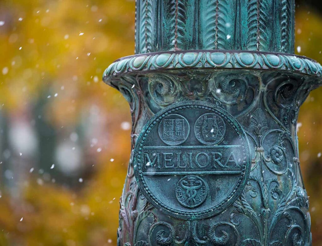 The University of Rochester's "Meliora" logo on a lamp pole