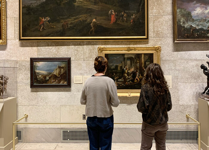 Two visitors looking at works of art in the Fountain Court