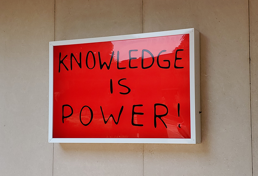 A lightbox with the text "Knowledge is Power!" in black handwriting against a red background