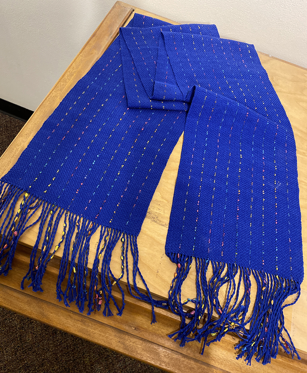 Woven bright blue scarf shot thought with metallic ribbons