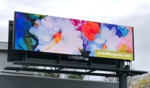 A billboard with brightly colored floral art on it