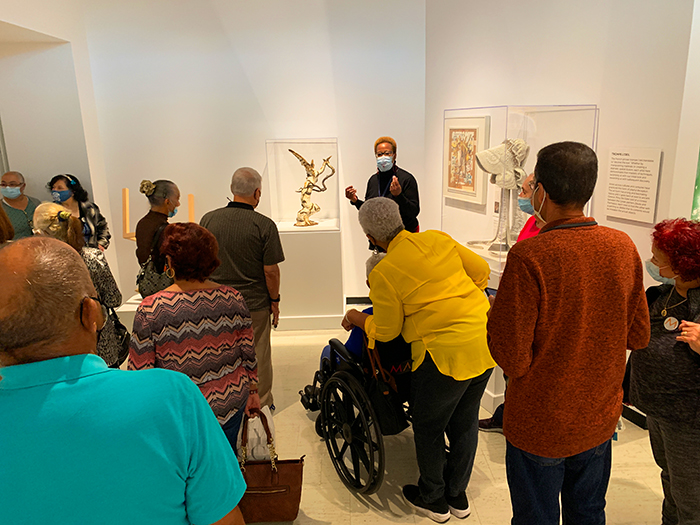 A tour group of senior citizens in the galleries