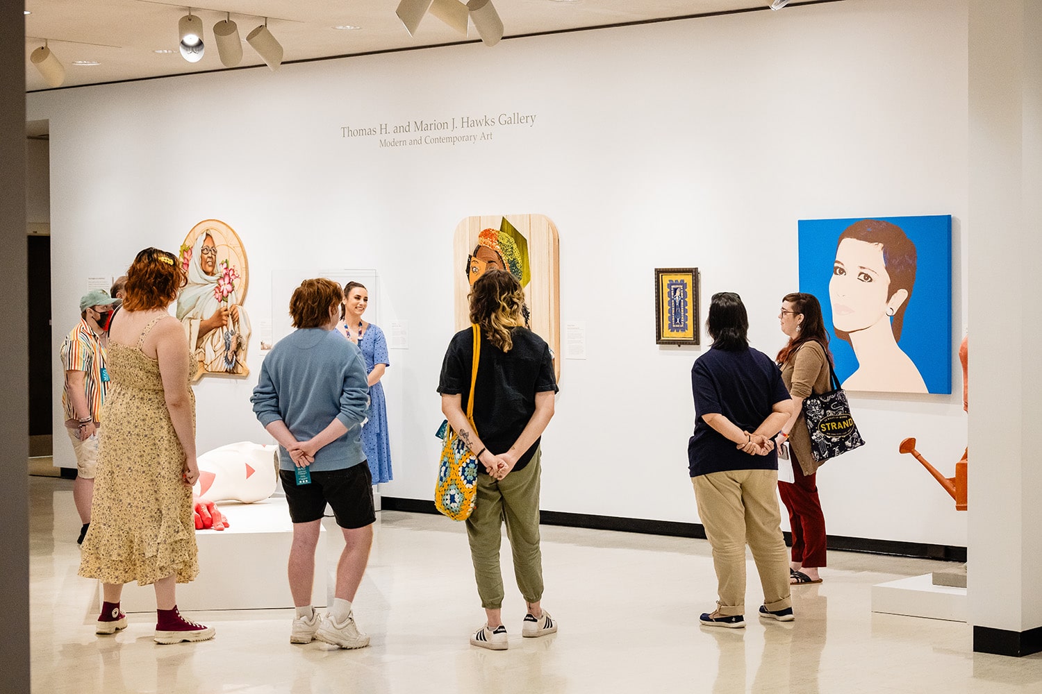 A group of visitors taking a tour in the galleries.