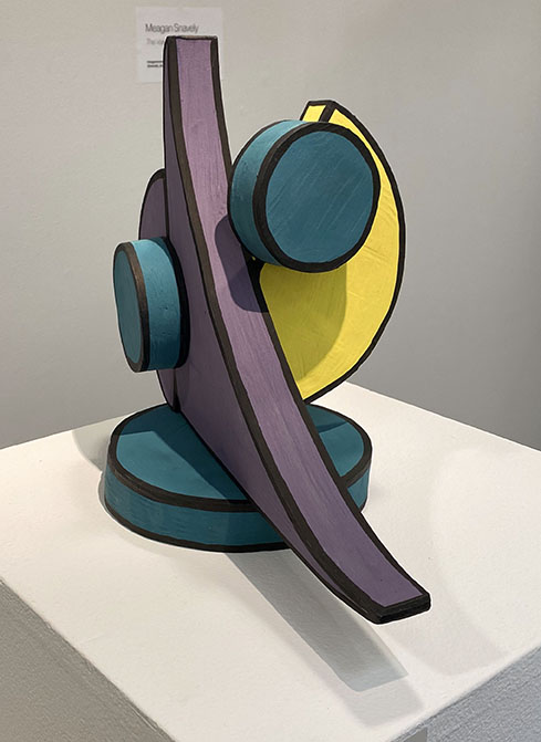 Sculpture of geometric shapes painted teal, purple, and yellow, edges painted black like lines