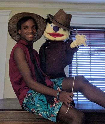Simmi Wallace holding a large puppet.