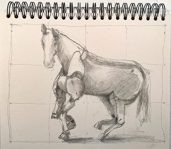 A page in a spiral bound sketchbook is turned to a rough pencil sketch of a side view of wooden horse statute looking at the viewer as if its caught in a motion running.