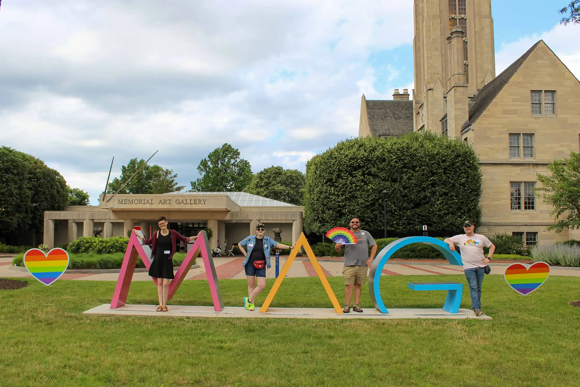People posing with the MAG sign at the 2023 Pride Celebration Day.