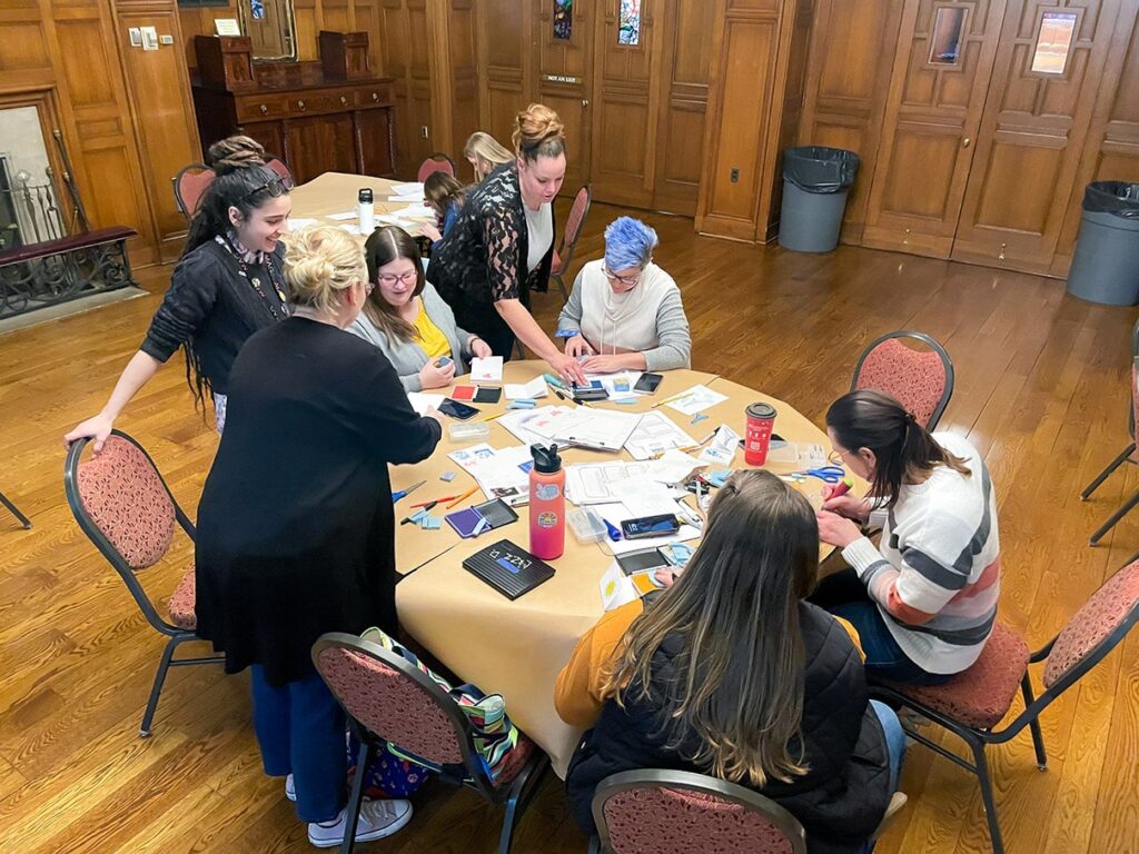 Creative Workshop artists leading teachers in a stamp-making activity.