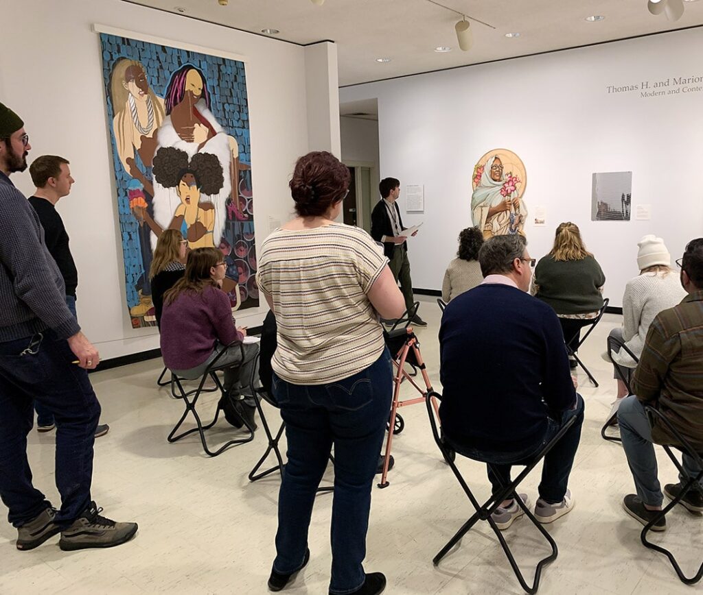 A museum educator leading a discussion with teachers in the galleries.