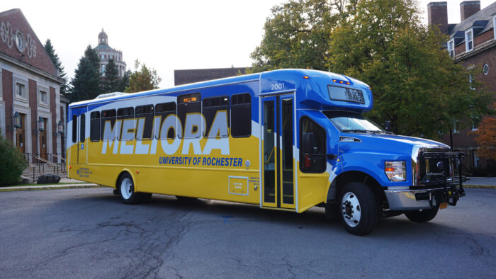 University of Rochester shuttle bus with new blue and yellow wrap.