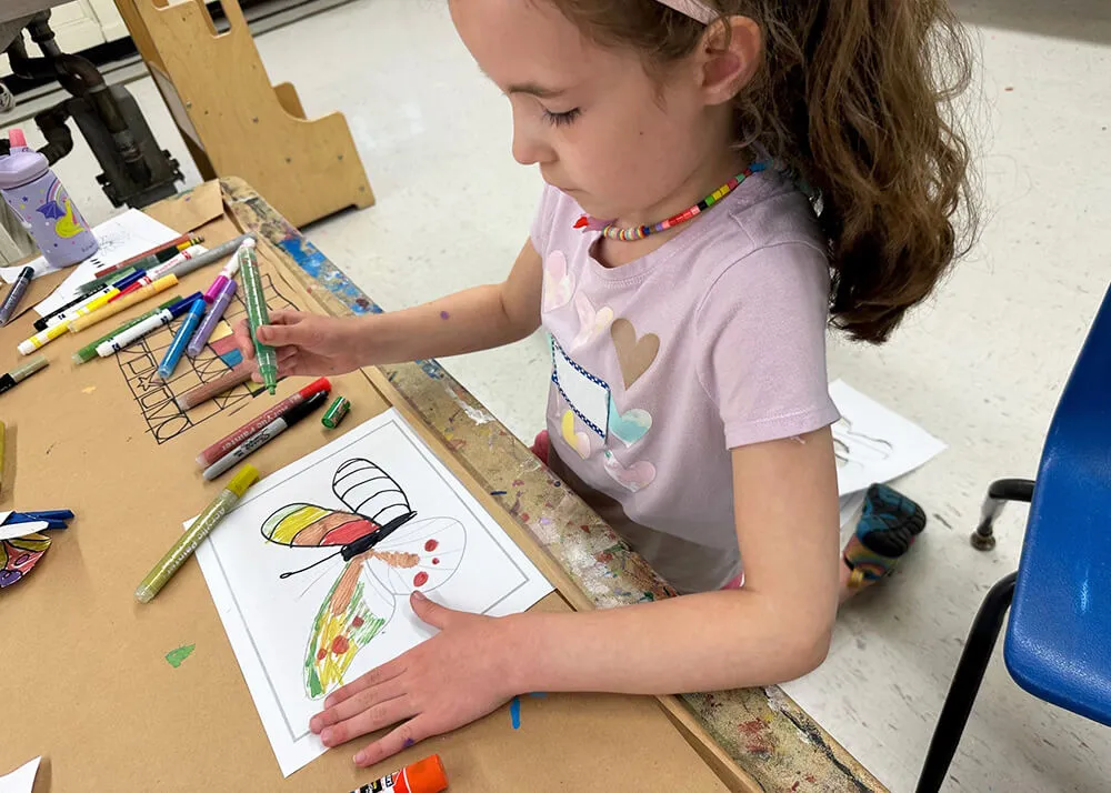 A girl drawing a butterfly.
