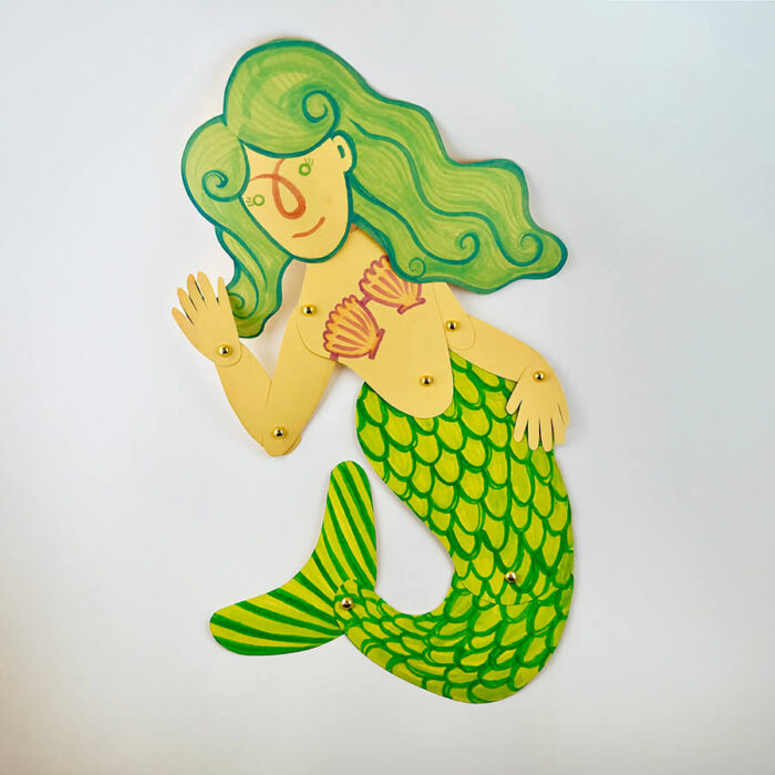 A mermaid puppet made out of paper.