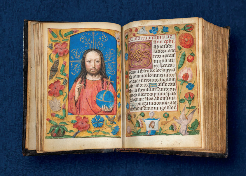 MAG's Ghent-Bruges Book of Hours open to a spread with a painting of Jesus on the left and richly illuminated text on the right.