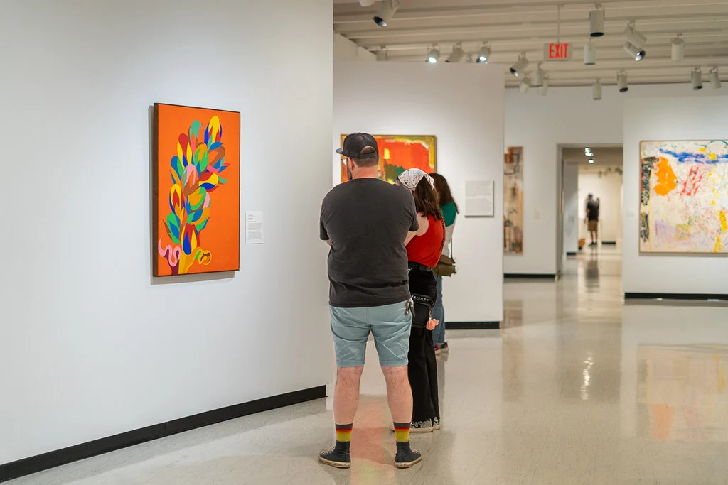 A group of visitors in the contemporary art gallery at MAG.