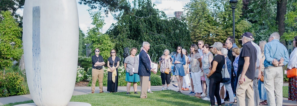 A staff member leading members on a tour of the Centennial Sculpture Park.