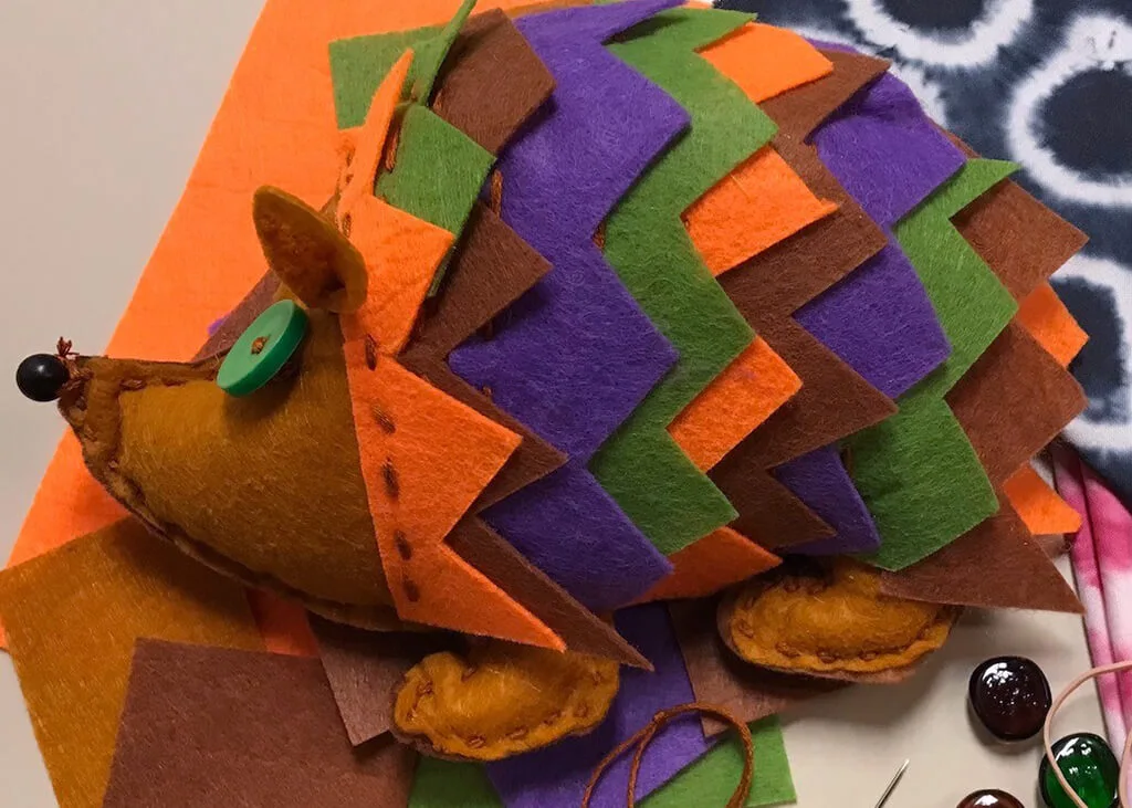 A colorful hedgehog hand-sewn out of felt.