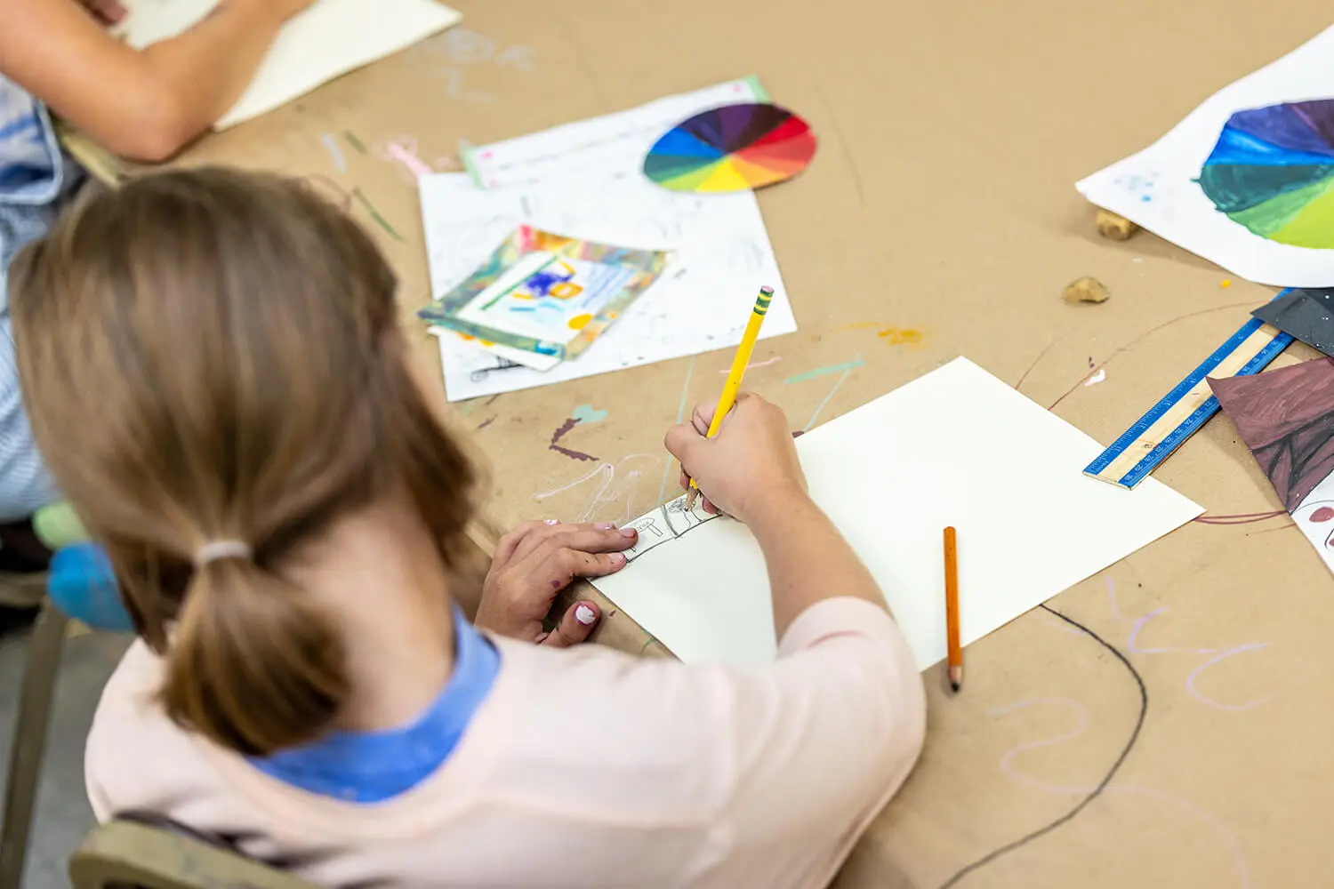A girl drawing a comic in the Creative Workshop.