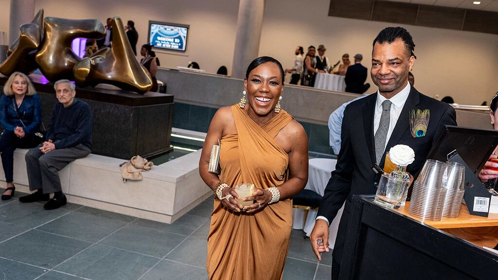 Two people in cocktail dress enjoying themselves in the Vanden Brul Pavilion at MAG.
