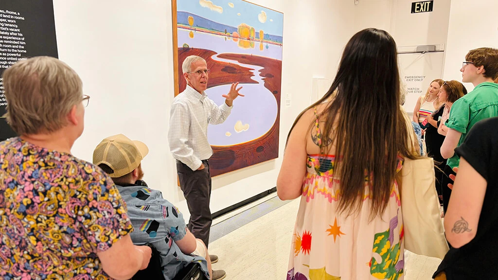 A docent giving a tour of the contemporary galleries to a group of visitors.