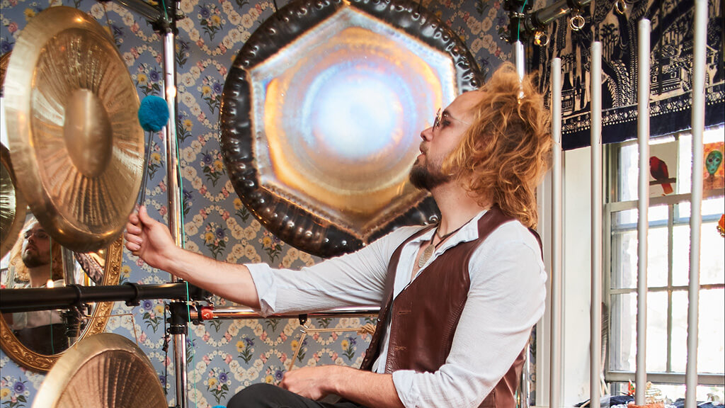 Performer Harold Taddy playing a gong.