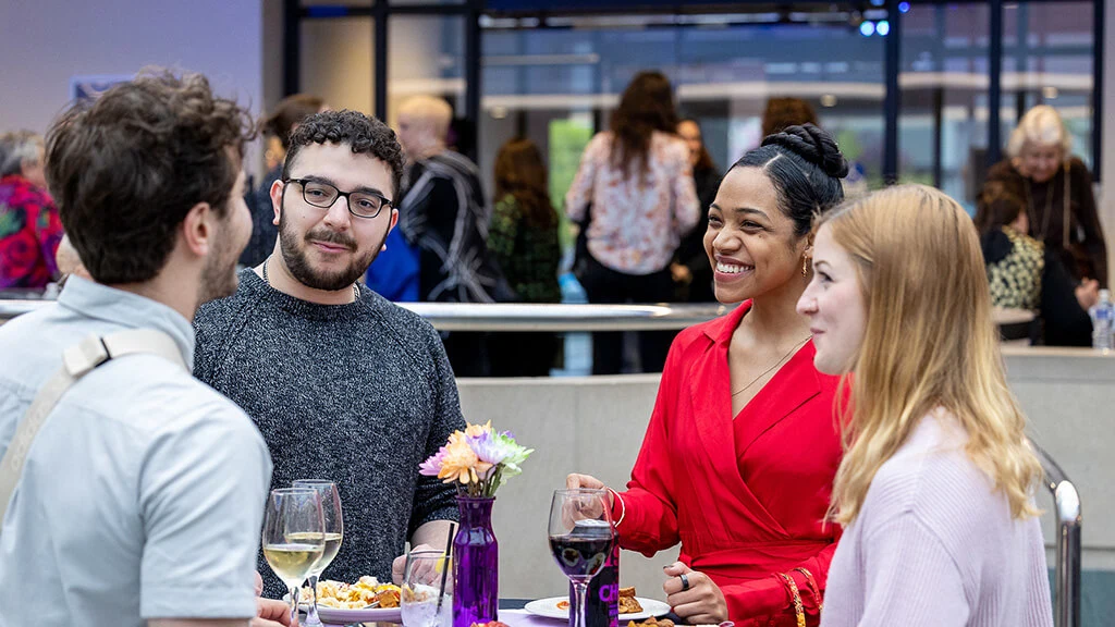 Young people talking at a party in the Vanden Brul Pavilion.