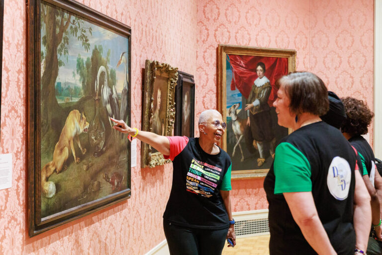 A tour guide giving a tour in MAG's European art galleries.