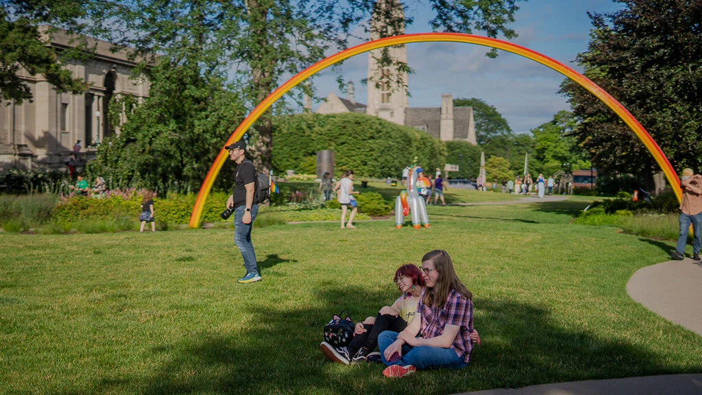 People hanging out on the law in front of MAG at 2024 Pride Celebration Day.
