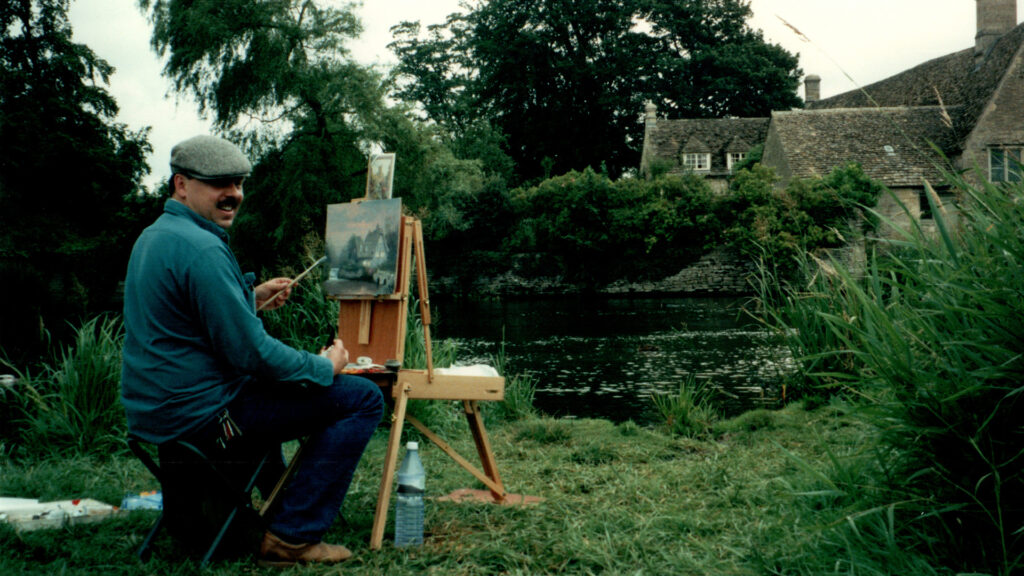 Thomas Kinkaide painting a landscape in the countryside