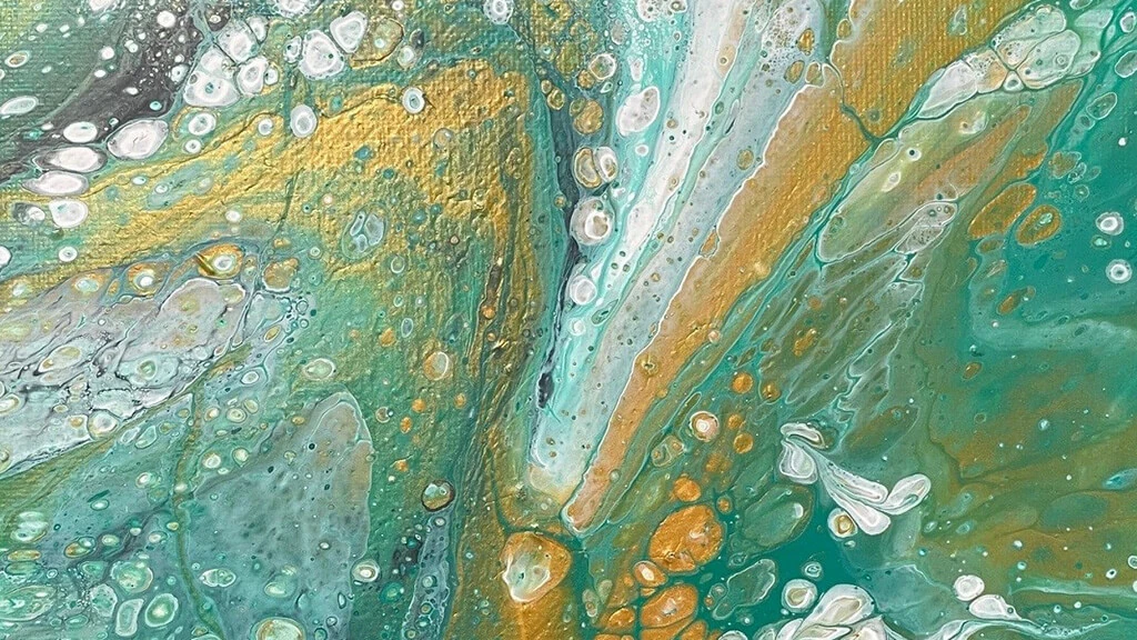 A part of a painting in gold, white, and shades of teal, created by pouring and dripping paint on the canvas.