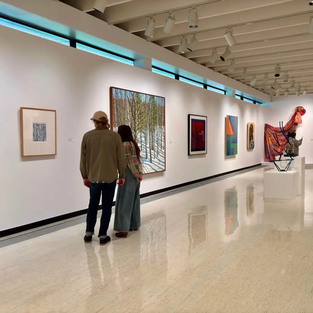 Two museum visitors looking at one of the works in MAG's contemporary art galleries.