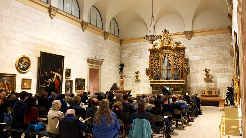 Visitors attending an organ concert in the Fountain Court.