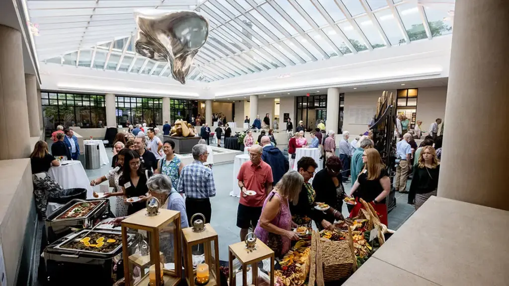 Members mingling at an exhibition opening party.